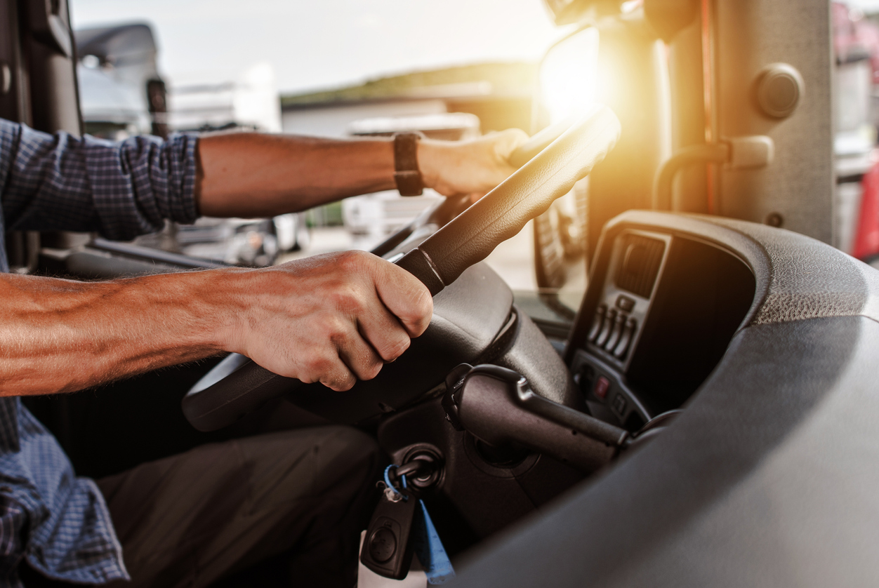 Closeup of truck driver using steering wheel