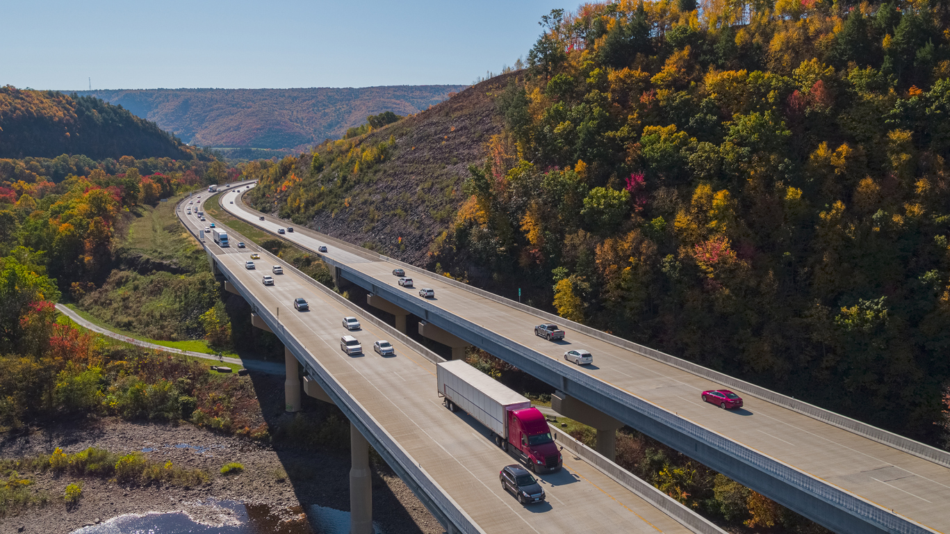 Scenic aerial view of the high bridge at the Pennsylvania Turnpike lying between mountains in Appalachian on a sunny day in fall.