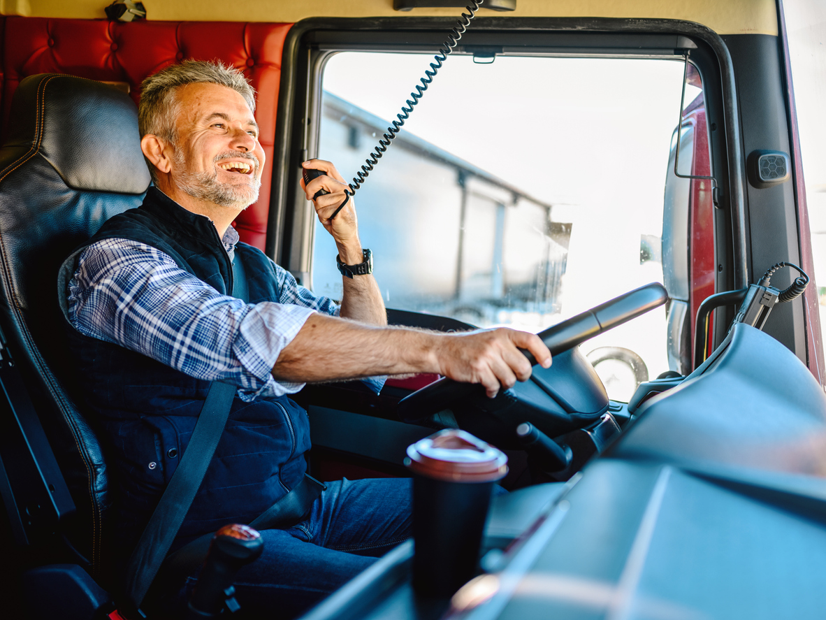 CB Radio Talk While on the Road. Truck Driver Using Radio To Contact Other Convoy Drivers.