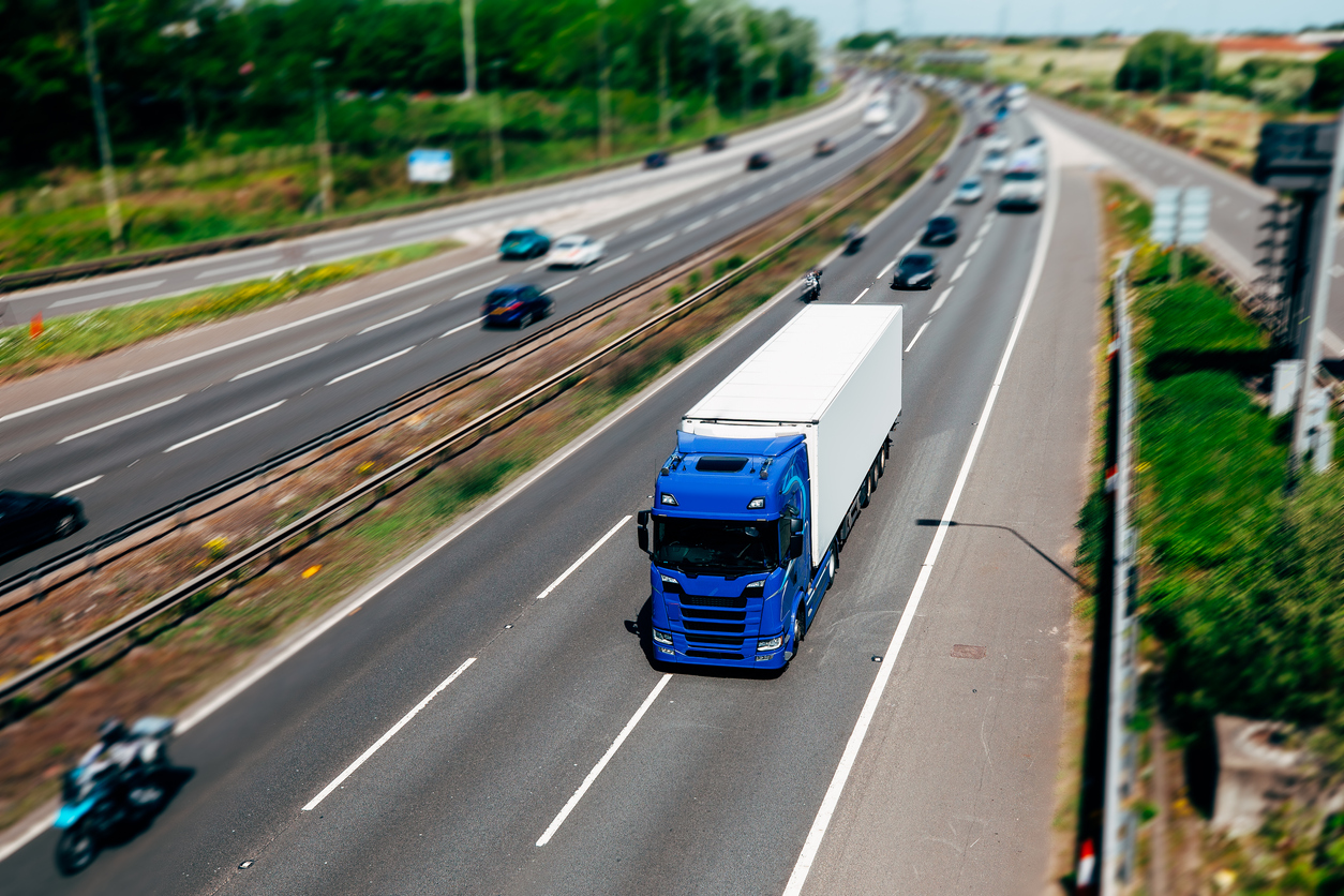 Orange Lorry on a motorway in motion near London, United Kingdom