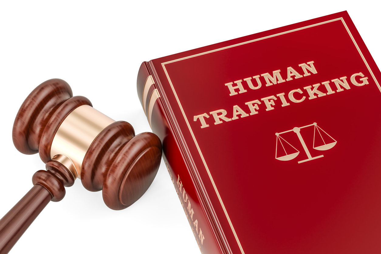 Human trafficking concept with gavel and book, 3D rendering