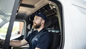 Delivery man sitting in a delivery van