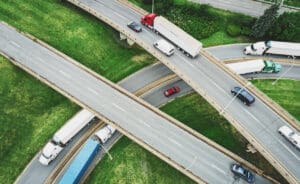 Aerial view of semi trucks on a highway interchange. (Composite image)