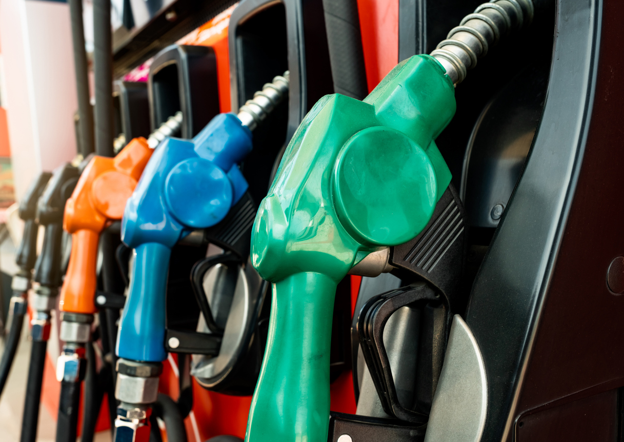 Petrol pump filling fuel nozzle in gas station. Fuel dispenser machine. Refuel fill up with petrol gasoline. Petrol industry and service. Red petrol fuel nozzle. Petroleum oil industry. Oil crisis.