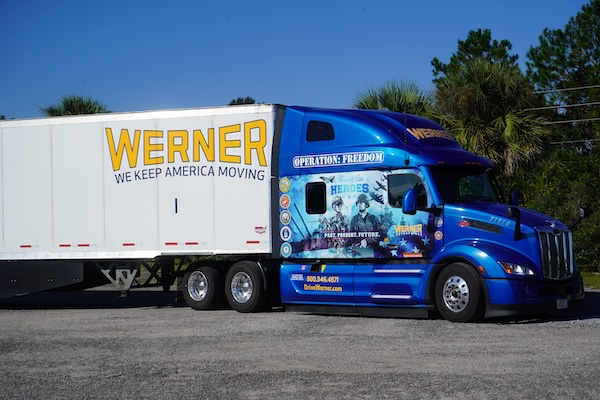A photo of a commercial truck with the Werner company logo on it and a picture of military members under the headline Operation: Freedom.