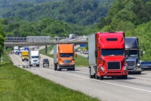 A steady flow of semis lead the way down a busy interstate highway, which begs the question about the difference between interstate and intrastate CDL